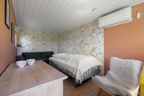 a small room with a bed and a chair at 20165-Samso-Marup-Bakkevej-14 in Mårup