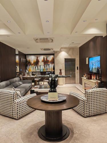 a living room with a couch and a table at Boutique Hotel in Baghdād