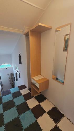 a bedroom with a dressing table and a mirror at William's Vendégház in Várpalota