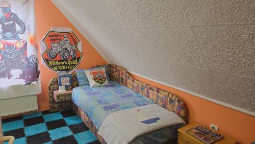 a small room with a bed in a attic at William's Vendégház in Várpalota