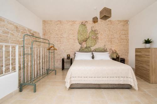 a bedroom with a bed and a brick wall at Martine Dimore Storiche di Puglia in Martina Franca