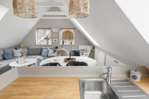 a kitchen with a sink and a living room at 20430-Samso-Ballenvej-34A in Ballen