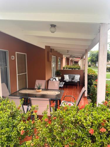 an outdoor patio with a table and chairs at Villa Paradise in Jacó