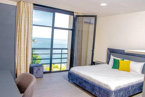 a bedroom with a bed and a large window at Venue 360 Hotel in Freetown
