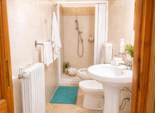 a bathroom with a sink and a toilet and a shower at Guglielmo room's B&B in Catania