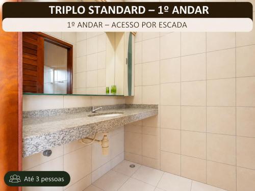 a bathroom with a sink and a mirror at Pousada Sunrise Beach in Cumbuco