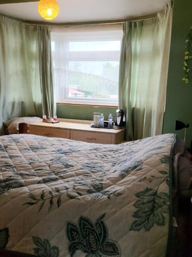 a bedroom with a large bed and a window at Hideaway Retreat 1 & 2 in Belvedere
