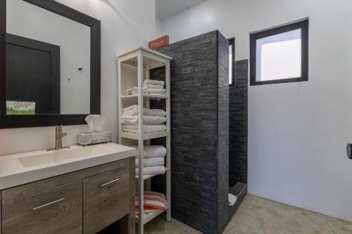 a bathroom with a sink and a mirror at Las Palmas Hotel - Cerritos Beach in El Pescadero