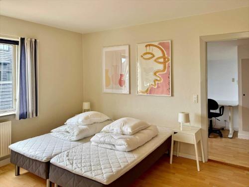 a bedroom with a bed with four pillows on it at 20432-Samso-Klintevej-6 in Ballen