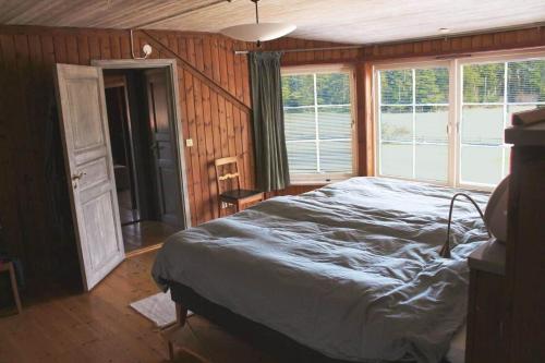 a bedroom with a bed and a large window at GOT698-Laerbro-Rute-Sofiero-133 in Lärbro