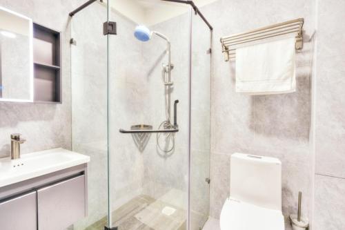 a bathroom with a shower and a toilet and a sink at Sasha BnBs in Nairobi