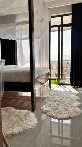 a bedroom with a bed with a view of the ocean at Sasha BnBs in Nairobi