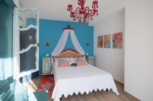 a bedroom with a white bed with a canopy at In ta Villa da u Perinetti in Bastia