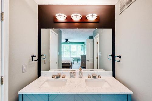 a bathroom with two sinks and a large mirror at 'Heart Pond Resort' Home in Carmel-Westfield Area in Carmel