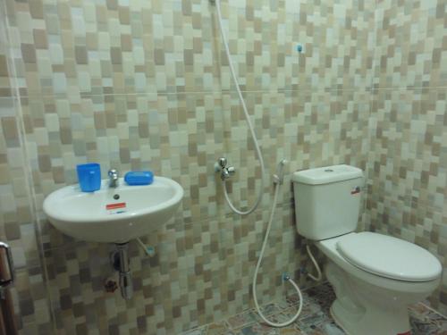 a bathroom with a toilet and a sink at SunRise Villa in Kampong Cham