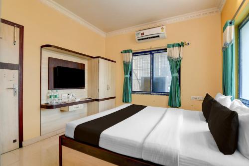 a bedroom with a large bed and a television at Hotel O Shyam sundar Hotel in kolkata