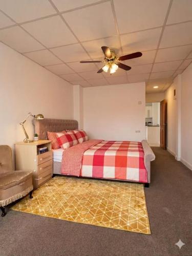 a bedroom with a bed and a ceiling fan at Stylish Studio with SuperKing Bed in Stonewood