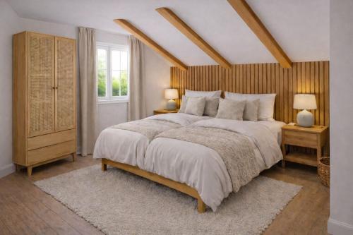 a bedroom with a large bed and a window at Seehaeuser am Lindenhof in Lychen