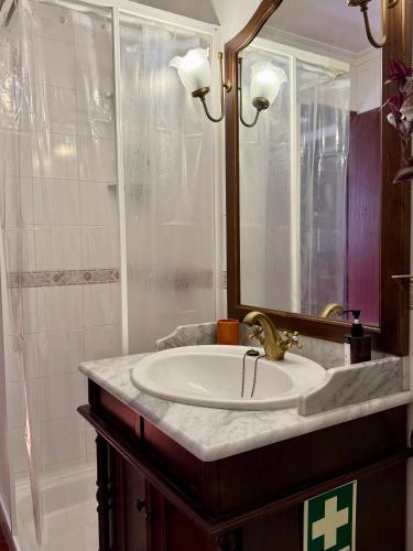 a bathroom with a sink and a shower at Casa D Dinis in Alfaiates