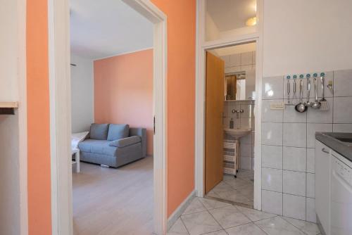 a kitchen and a living room with a blue couch at Apartments Saric in Jadrtovac