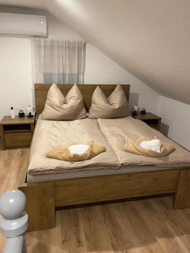 a bed with two pillows on it in a room at Bobo Hegyi Kuckó in Sárvár