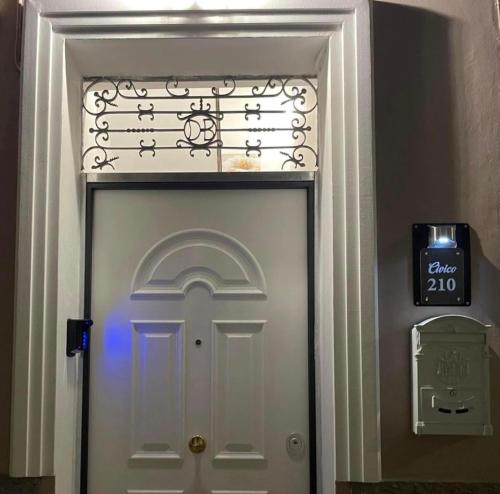 a white door with a sign on top of it at Civico 210 in Itri