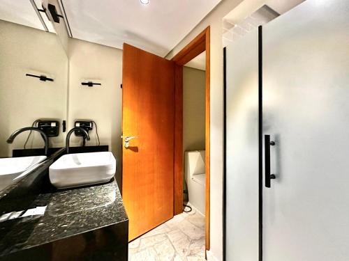 a bathroom with a sink and a toilet at Luna Hotel Boutique - Frente à Praia in Guarujá