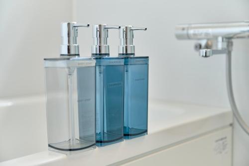 a laboratory with three glass cylinders on a shelf at Suikomareso 2 水処稀荘 三隈川別館 in Hita