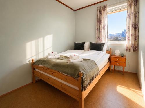 a bedroom with a bed with two stuffed animals on it at KB - Waterfront Villa Sørvågen in Moskenes