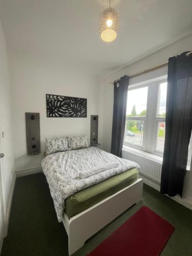 a bedroom with a bed and a window at Eva lodges in Manchester