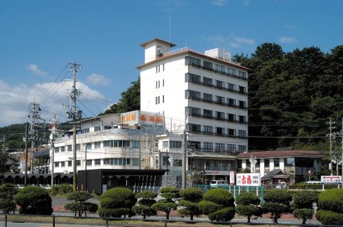 a large white building with trees in front of it at Kinpokan in Toba