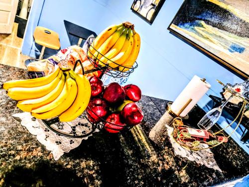 a bunch of bananas and apples on a counter at 2 BEDROOM APARTMENT 20 min-Newark Airport 15 min- Stadium Downtown Newark- Branch Brook park inn in Newark