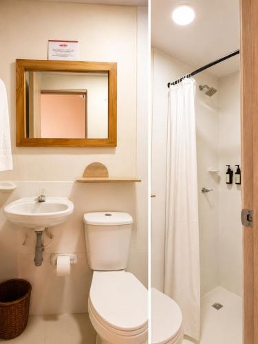 a bathroom with a toilet and a sink and a mirror at ETHNIC Thematic Hotel in Cartagena de Indias