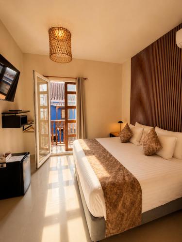 a bedroom with a large bed and a window at ETHNIC Thematic Hotel in Cartagena de Indias