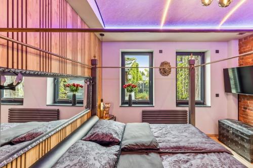 a bedroom with two beds and a tv at Ambiente Apartment in Olfen