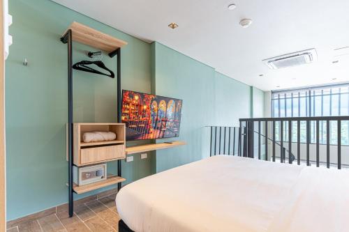 a bedroom with a bed and a blue wall at Stylish Duplex Loft - Panoramic Rooftop Pool in Cartagena de Indias