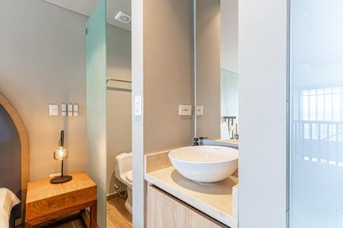 a bathroom with a bowl sink and a toilet at Stylish Duplex Loft - Panoramic Rooftop Pool in Cartagena de Indias