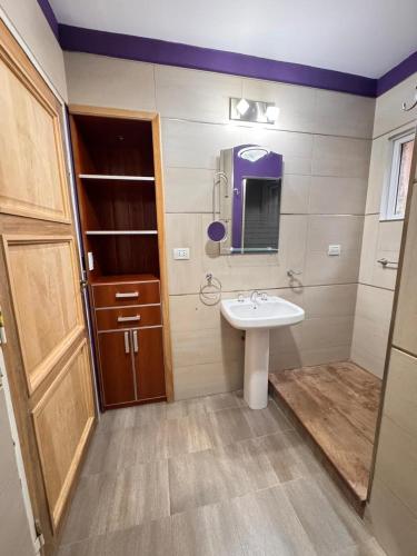 a bathroom with a sink and a mirror at Barrio Parque Residence in Caleta Olivia