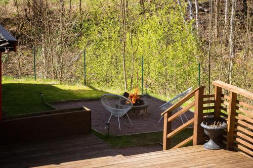 a patio with a table and a fire pit at the Little Oasis In Gothenburg in Gothenburg