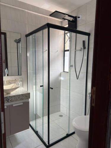 a bathroom with a shower and a toilet and a sink at RESIDENCIAL MORADA DO VALE 03b in Garanhuns