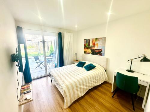a bedroom with a bed and a desk and a window at Gare sud in Rennes