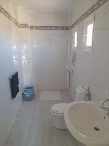 a white bathroom with a toilet and a sink at Taguermess Tag 8 in Taguermess