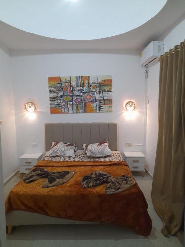 a bedroom with a bed and two night stands at Taguermess Tag 8 in Taguermess
