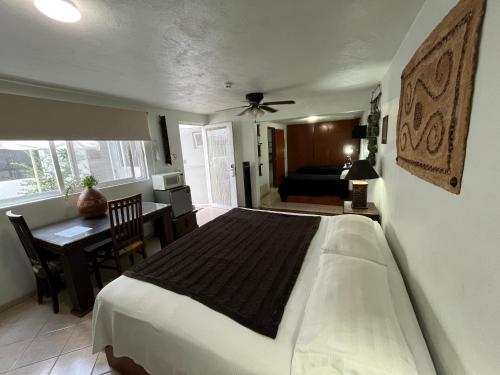 a bedroom with a large bed and a table with a desk at Residencia Sofía in Casa Blanca La Corregidora