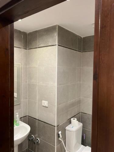 a bathroom with a toilet and a sink at Luxury Studio, pool, Private beach & close to Airport in Hurghada