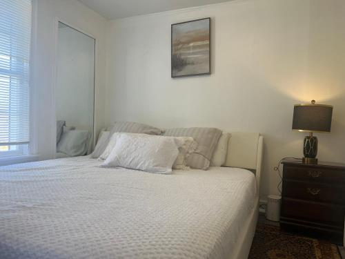 a bedroom with a bed with a teddy bear on it at Walnuts in Owings Mills