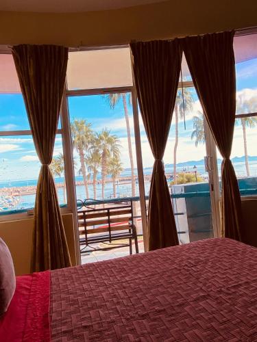 a bedroom with a bed and a view of the ocean at Hotel Marina Loreto in Loreto
