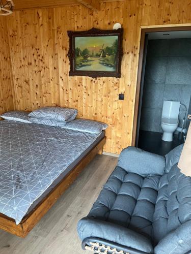 a bedroom with a bed and a couch in it at The Orchard Manor in Ociu