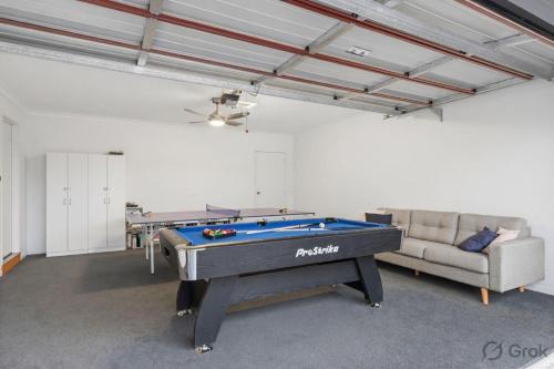 a living room with a pool table and a couch at Island Luxe Retreat Cowes in Cowes
