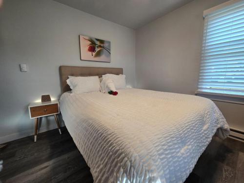 a bedroom with a bed with a white comforter at 2BR House Perfect for Olympic NP Adventures in Port Angeles
